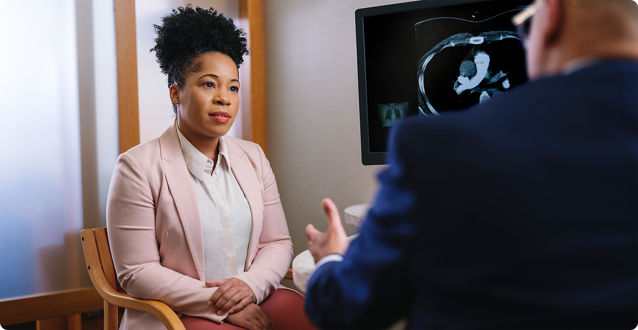 Female patient listening attentively to a Mayo Clinic doctor during a relaxed medical consultation.
