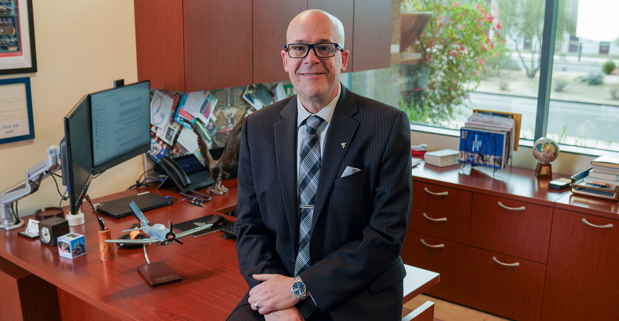 Executive Health patient in suit seated in an office sharing personal story of care and recovery.