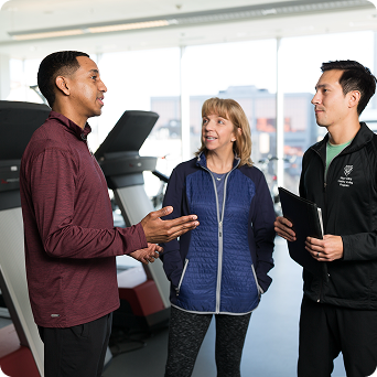 Three Mayo Clinic professionals standing in a lab setting discussing health insights and test results.