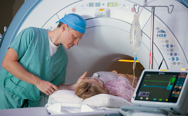 Technician comforting patient during an MRI scan.