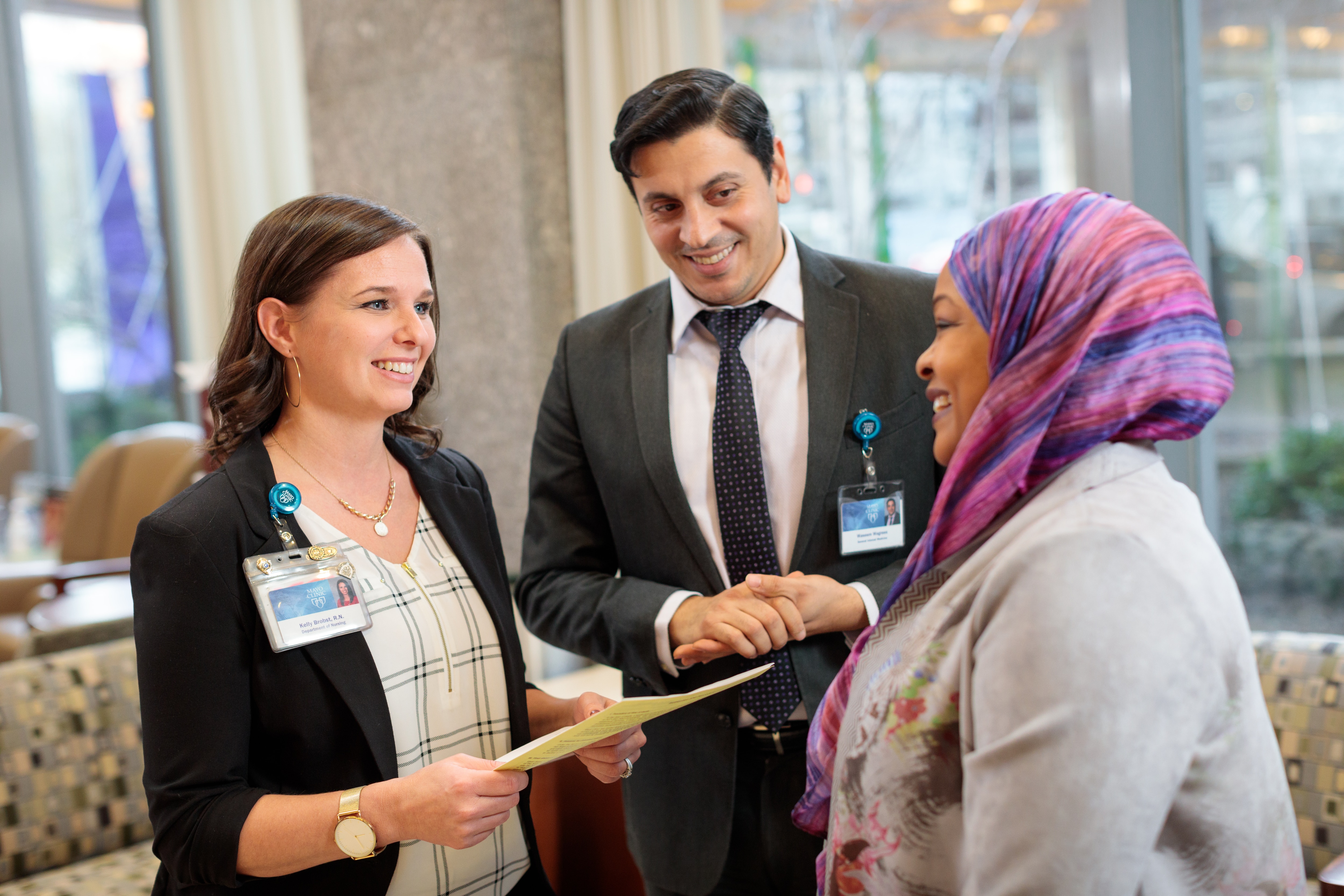 Two Mayo Clinic staff members review information with a patient.