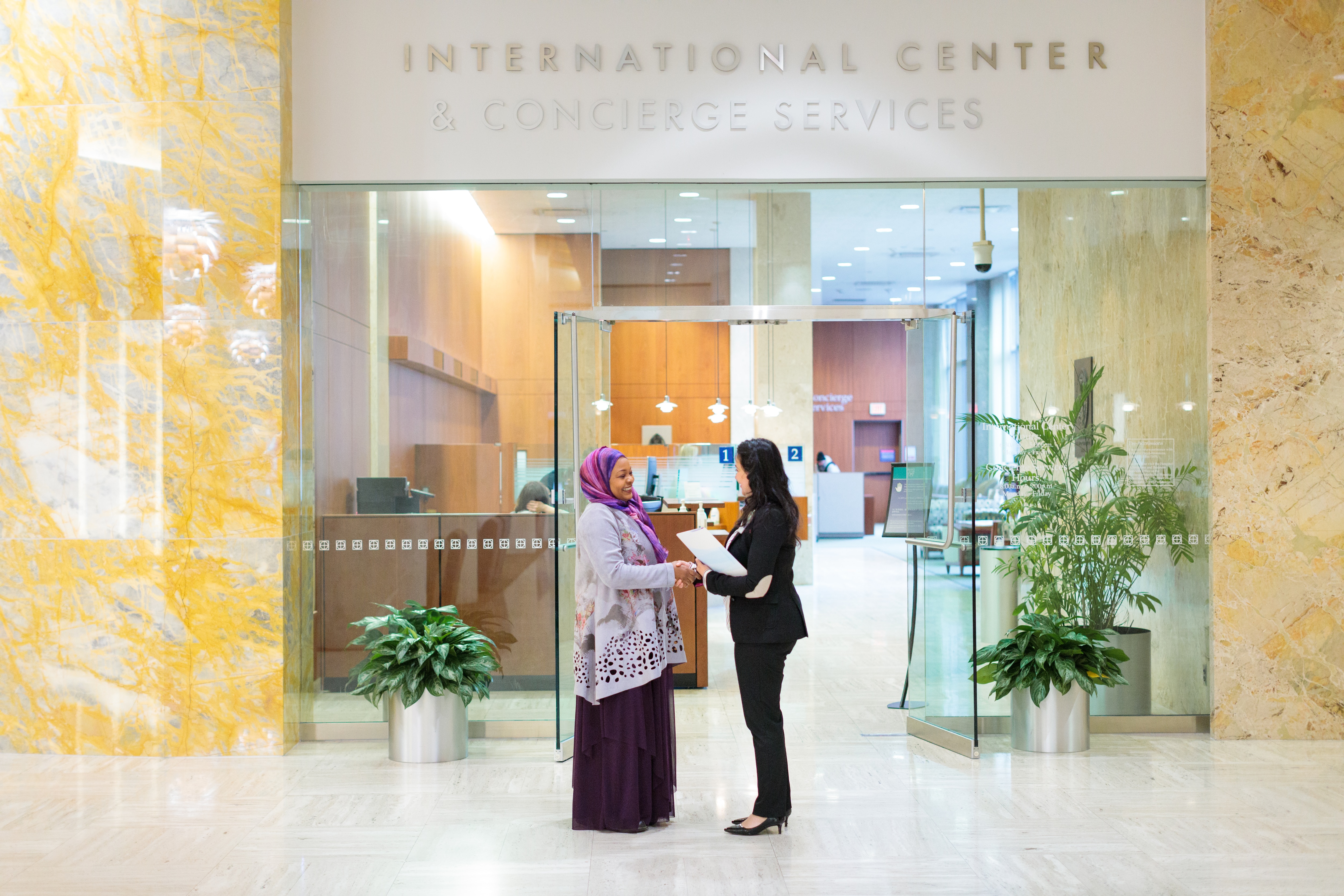 Mayo Clinic staff member reviews orientation information with a patient at the International Center.