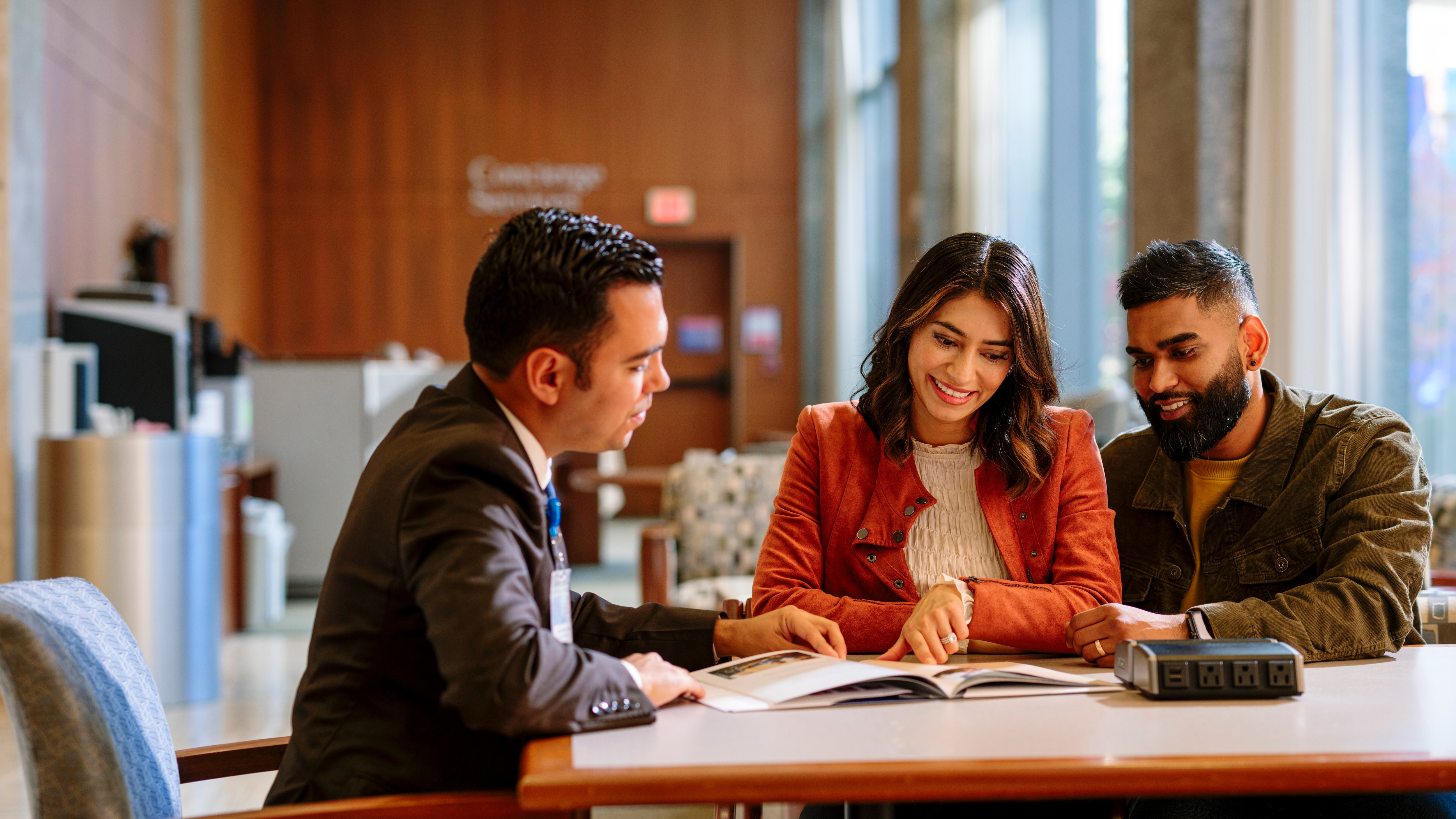 Mayo Clinic International Patient Coordinator reviews information with a patient and companion.